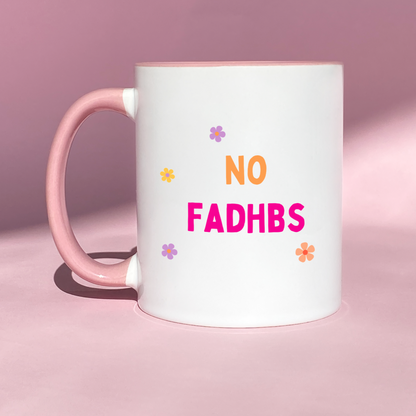 White ceramic mug with colorful flowers and the playful phrase 'No Fadhbs Just Vibes' in bold lettering.